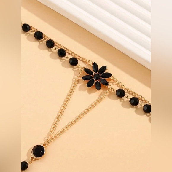 Elegant Black and Gold Floral Hand Chain - Picture 2 of 3
